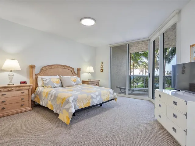 a spacious bedroom with a bed and a window