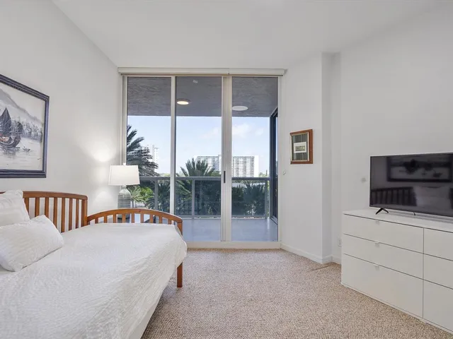 a bedroom with furniture and a flat screen tv