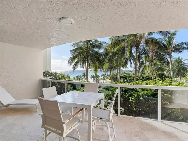 a view of backyard with swimming pool and outdoor seating