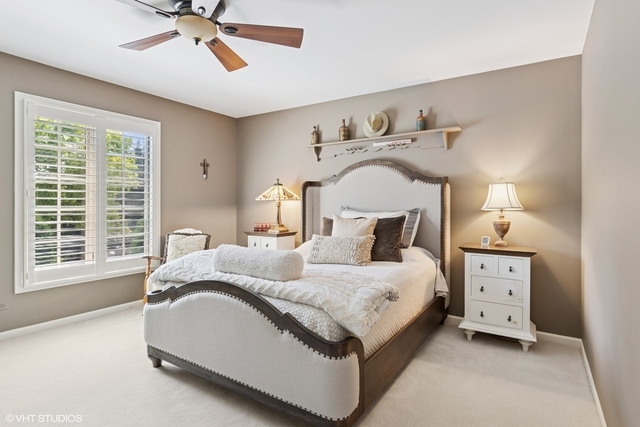 8S241 Dunham Drive Naperville, IL 60540 - Photo 15 of 27 a spacious bedroom with a bed and a window