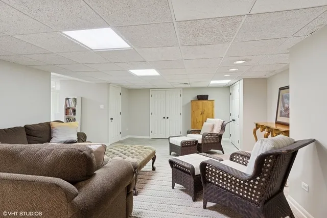 a living room with furniture a couch and kitchen view