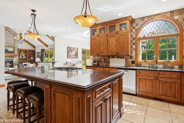 8S241 Dunham Drive Naperville, IL 60540 - Photo 5 of 27 a kitchen with stainless steel appliances granite countertop a sink a counter space and a view of living room