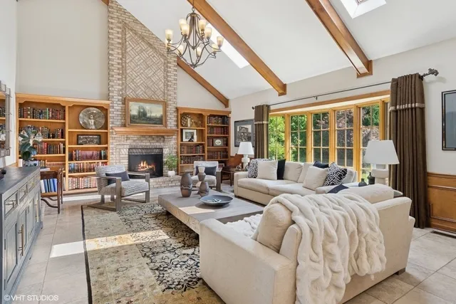 a large bedroom with furniture fireplace and a large window