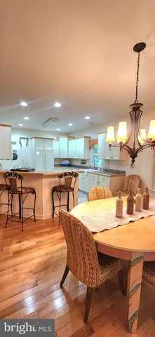 a dining room with furniture and a chandelier