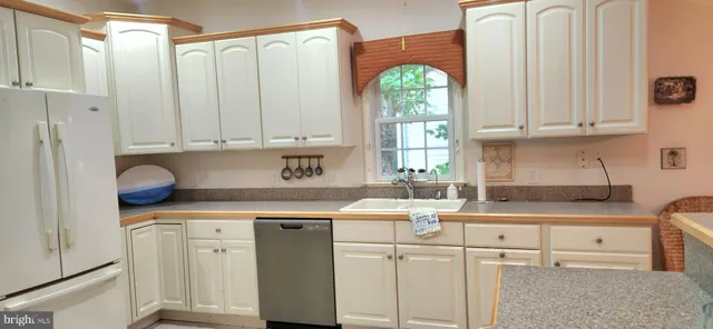 a kitchen with appliances cabinets and a window
