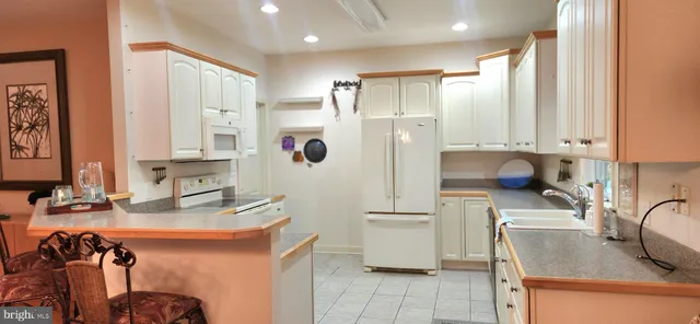 a kitchen with a sink and a refrigerator