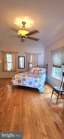 a bed room with a bed and a mirror