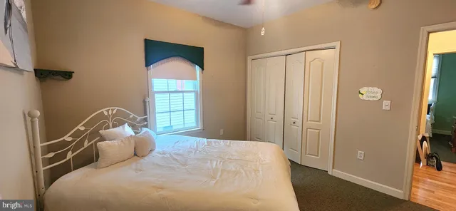 a bed sitting in a bedroom next to a window