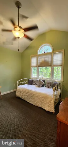 a view of a balcony with wooden chairs