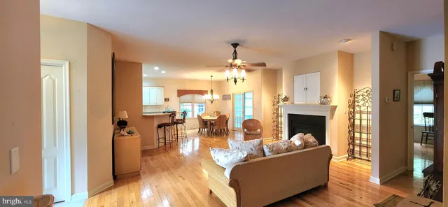 a living room with fireplace furniture and a chandelier