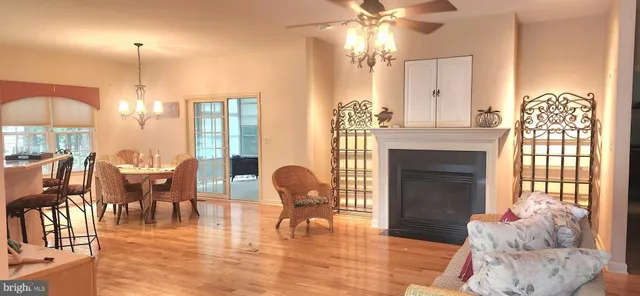 a dining room with furniture a chandelier and wooden floor
