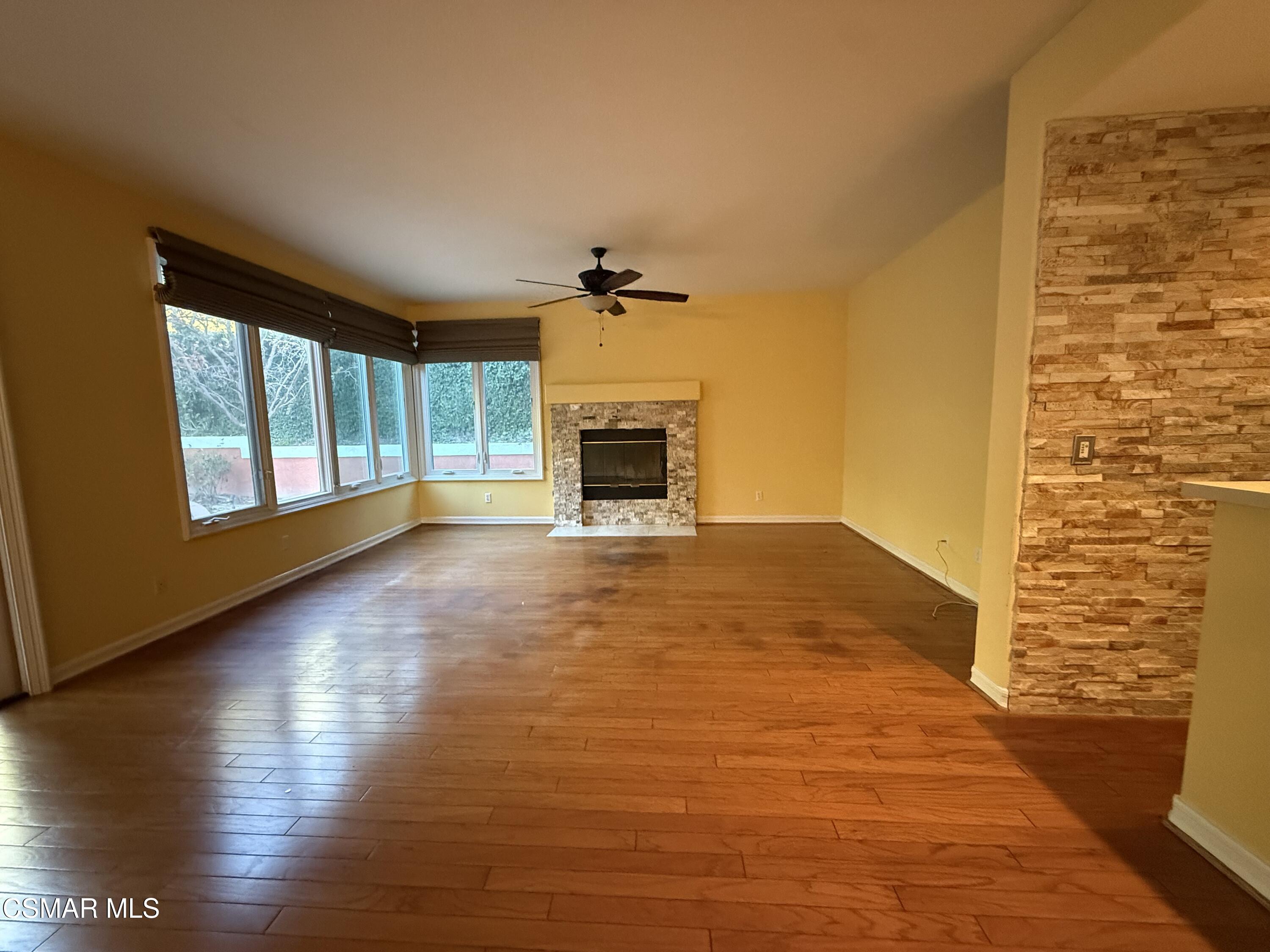 267 High Meadow Street Simi Valley, CA 93065 - Photo 13 of 36 a view of a livingroom with wooden floor a fireplace and window