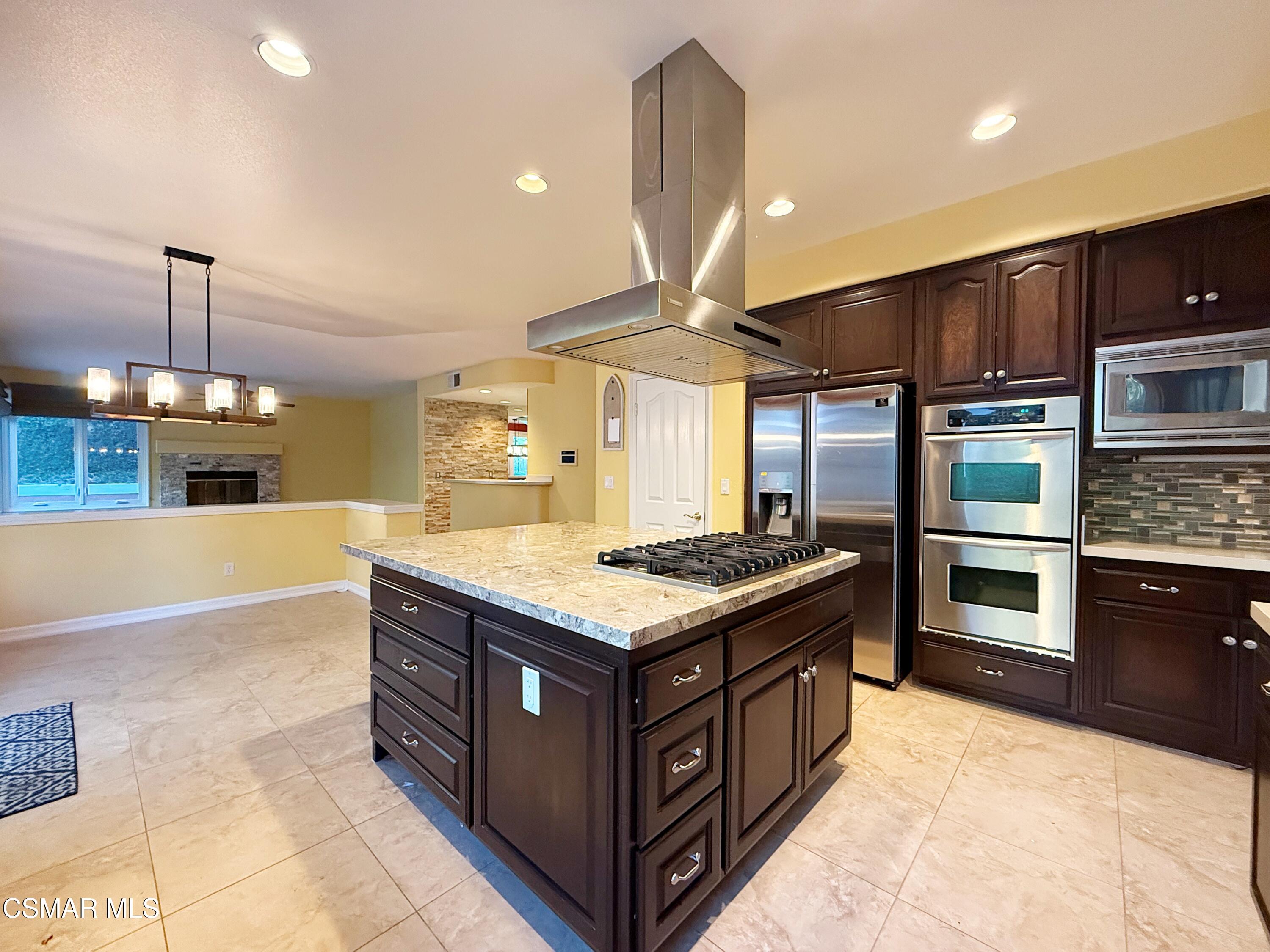 267 High Meadow Street Simi Valley, CA 93065 - Photo 10 of 36 a kitchen with a stove and a refrigerator