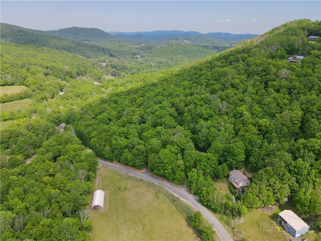 1173 Hopewell Church Road Boone, NC 28607 - Photo 38 of 39 a view of a lush green hillside and a houses