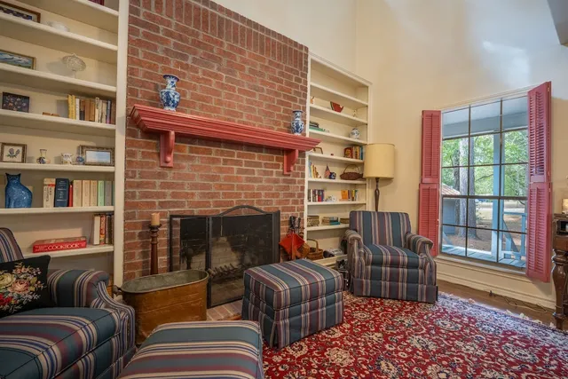 a bedroom with furniture and a fireplace