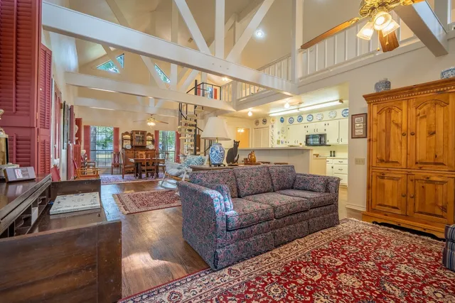 a living room with furniture and a chandelier