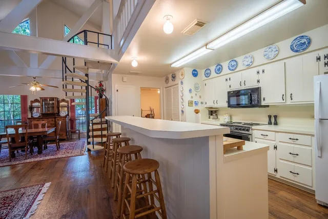 a kitchen with cabinets a sink and wooden floors