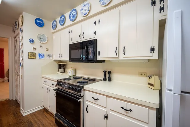 a kitchen with stainless steel appliances white cabinets and a stove