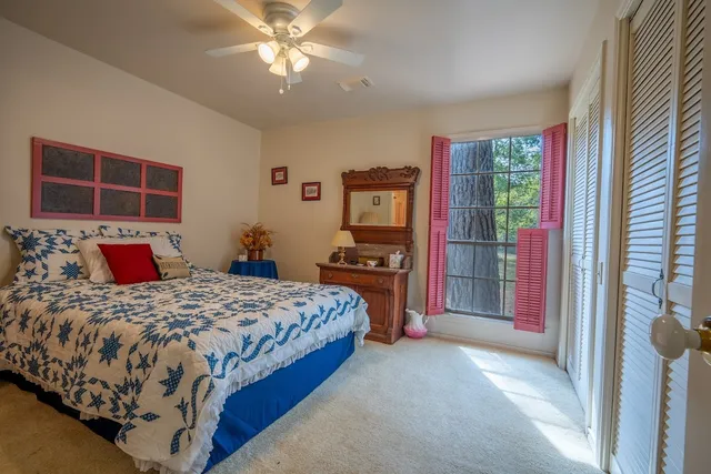 a bedroom with a bed dresser and a window