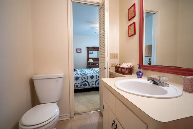 a bathroom with a toilet sink and mirror