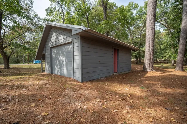 a view of a house with a yard and garage