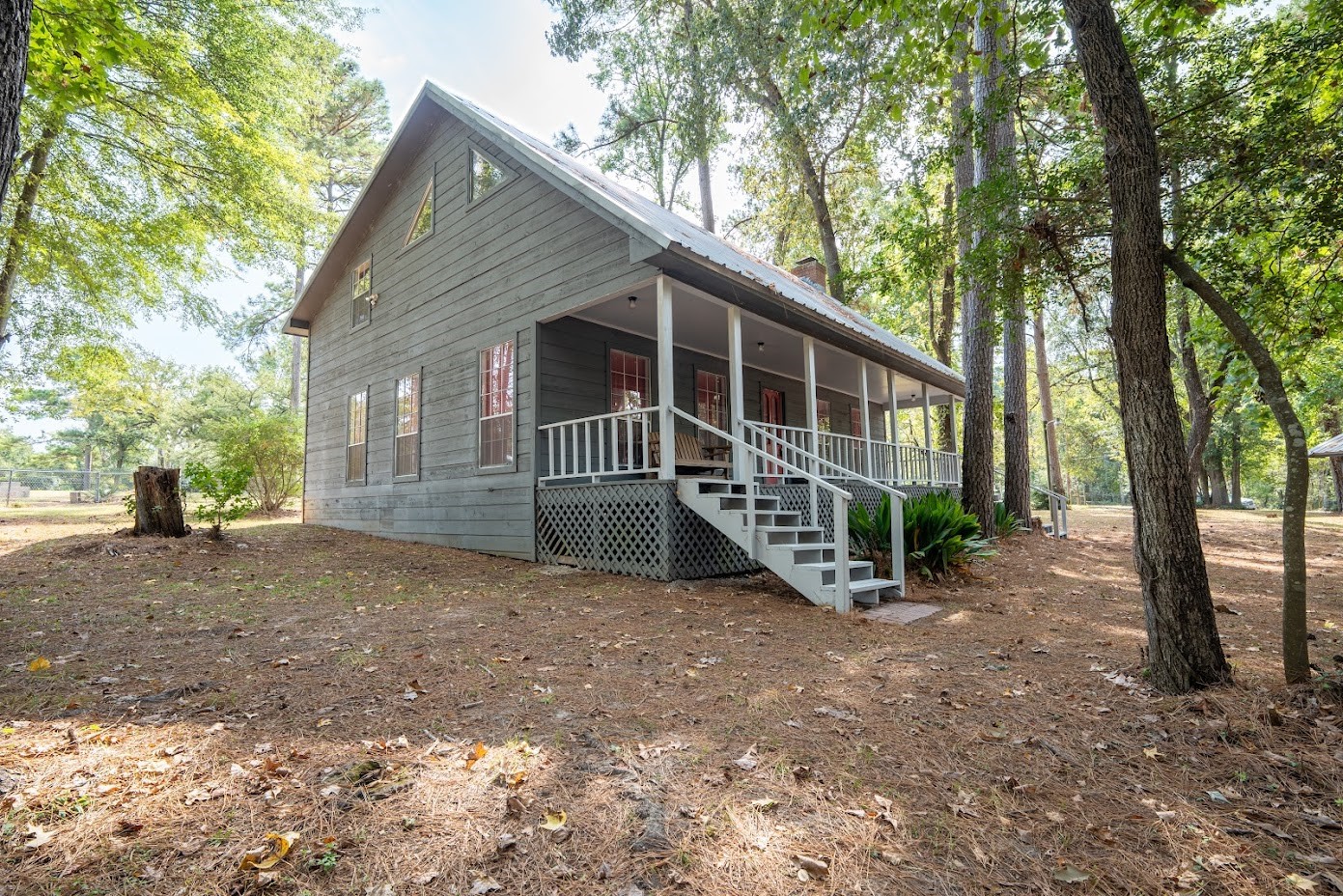 565 Timber Bay Drive Trinity, TX 75862 - Photo 10 of 49 a view of a house with a yard and a large tree