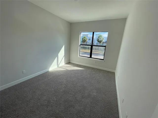 a spacious bathroom with a double vanity sink a toilet and a mirror
