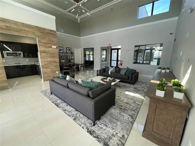 a kitchen with stainless steel appliances granite countertop a sink a refrigerator and a stove