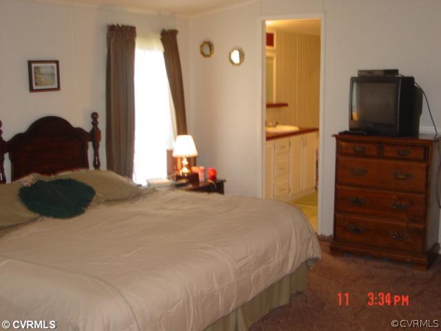 4601 Namozine Road Ford, VA 23850 - Photo 3 of 12 a bedroom with a bed and a television