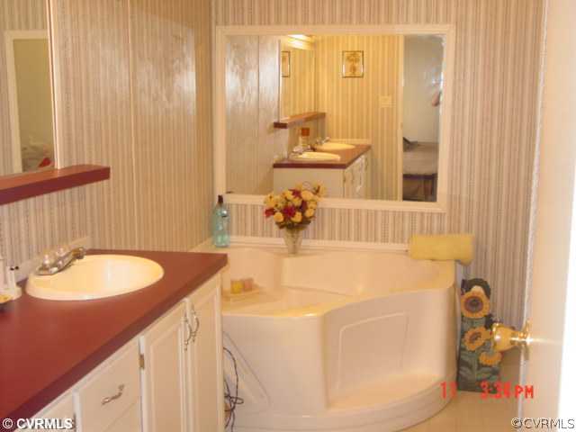 4601 Namozine Road Ford, VA 23850 - Photo 4 of 12 a bathroom with a sink and a mirror