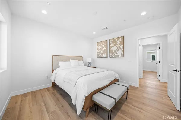 a bedroom with a bed and wooden floor