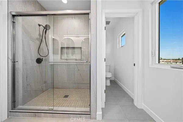 a bathroom with a glass shower door