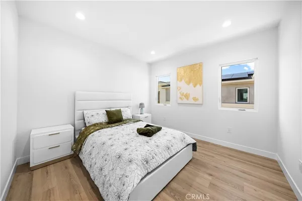 a bedroom with a bed and wooden floor