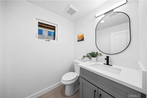 a bathroom with a sink a mirror and a toilet