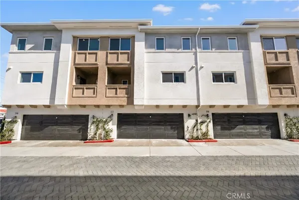 a front view of a house with large windows