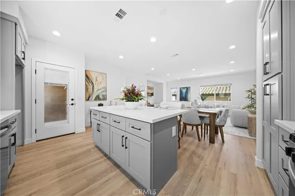 a kitchen with white cabinets stove and sink