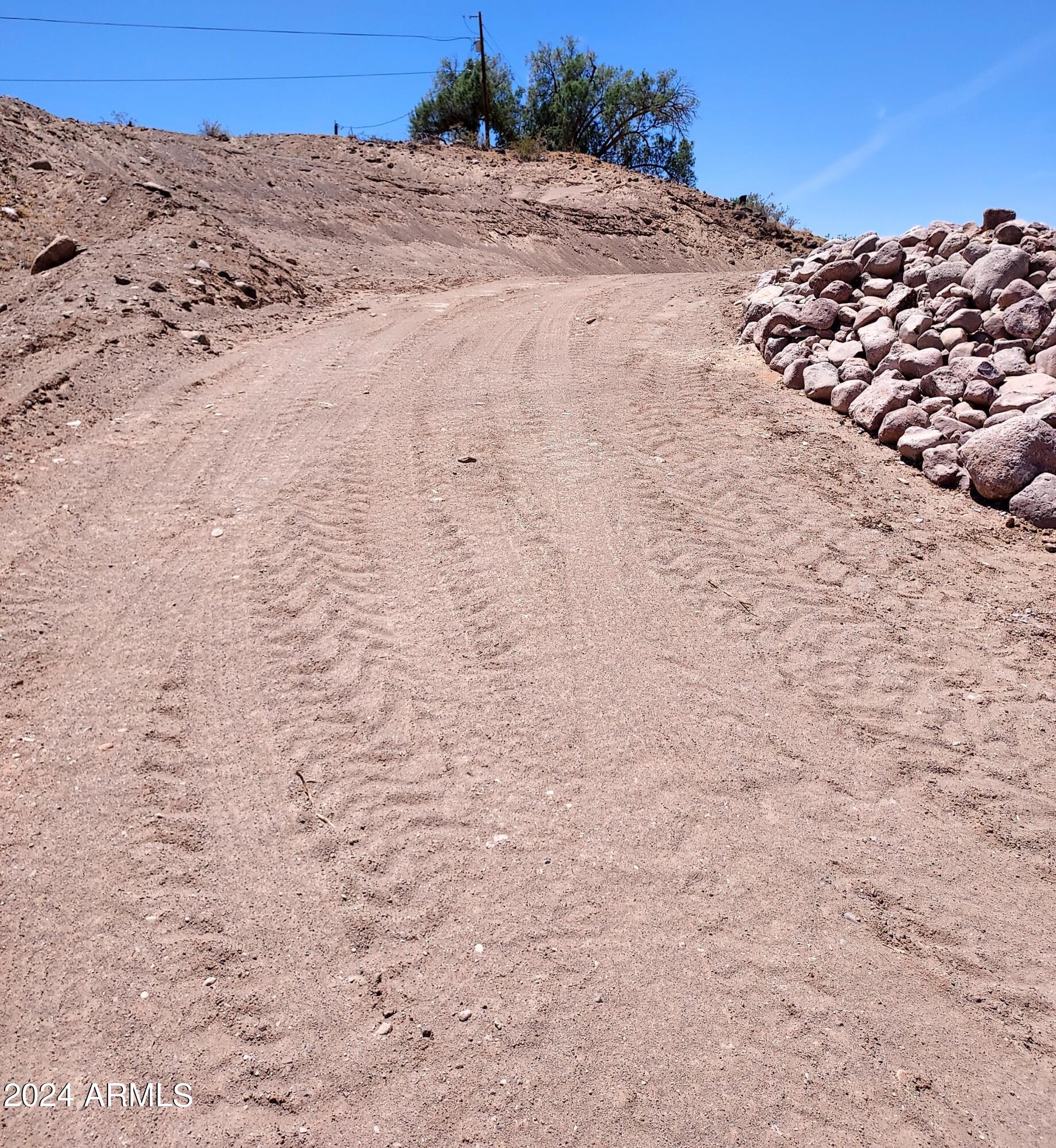 4530 Tanque Verde Drive, Unit 3 Topock, AZ 86436 - Photo 18 of 30 a view of a dry yard with a mountain