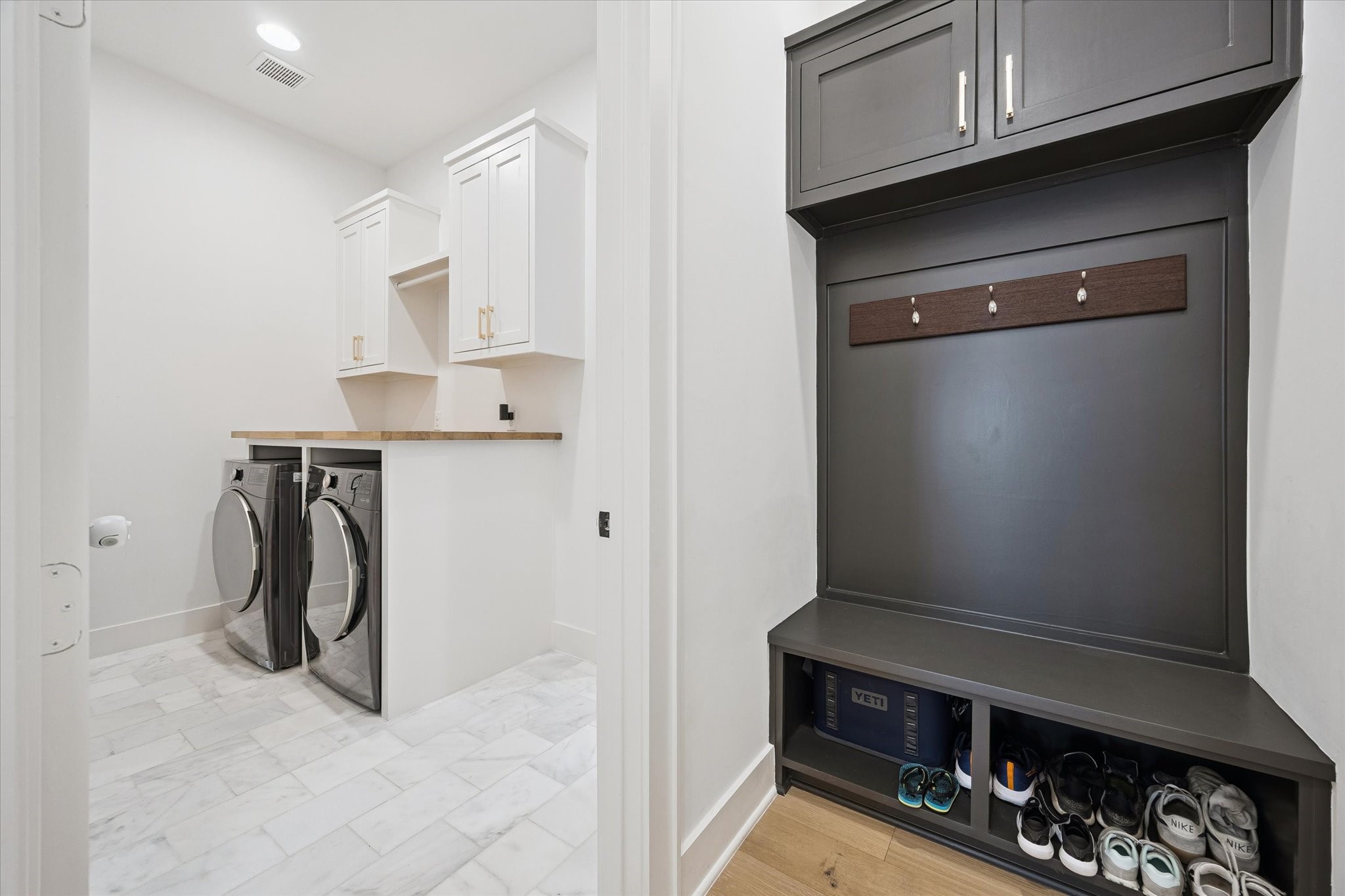 1313 Thornton Road Houston, TX 77018 - Photo 20 of 32 Designed for organization and functionality, the spacious laundry room is complemented by a custom mudroom with built-in lockers, overhead storage, and a convenient drop zone for everyday living.