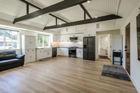 a view of a livingroom with furniture and a window