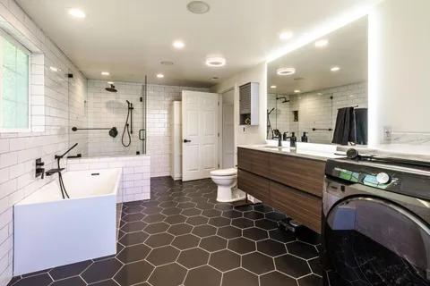 a large kitchen with kitchen island a sink stainless steel appliances and cabinets