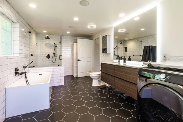 a large kitchen with kitchen island a sink stainless steel appliances and cabinets