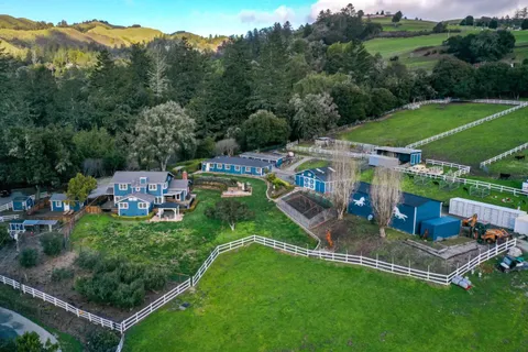 an aerial view of a house with a yard