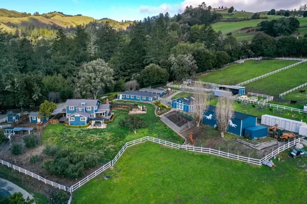 an aerial view of a house with a yard