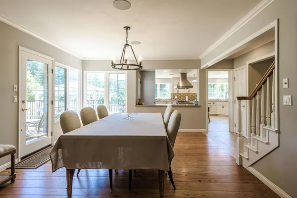 a view of a a dining room with furniture window and wooden floor