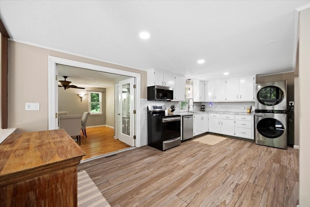 115 Douglas Road Webster, MA 01570 - Photo 11 of 42 a kitchen with a refrigerator and wooden floor