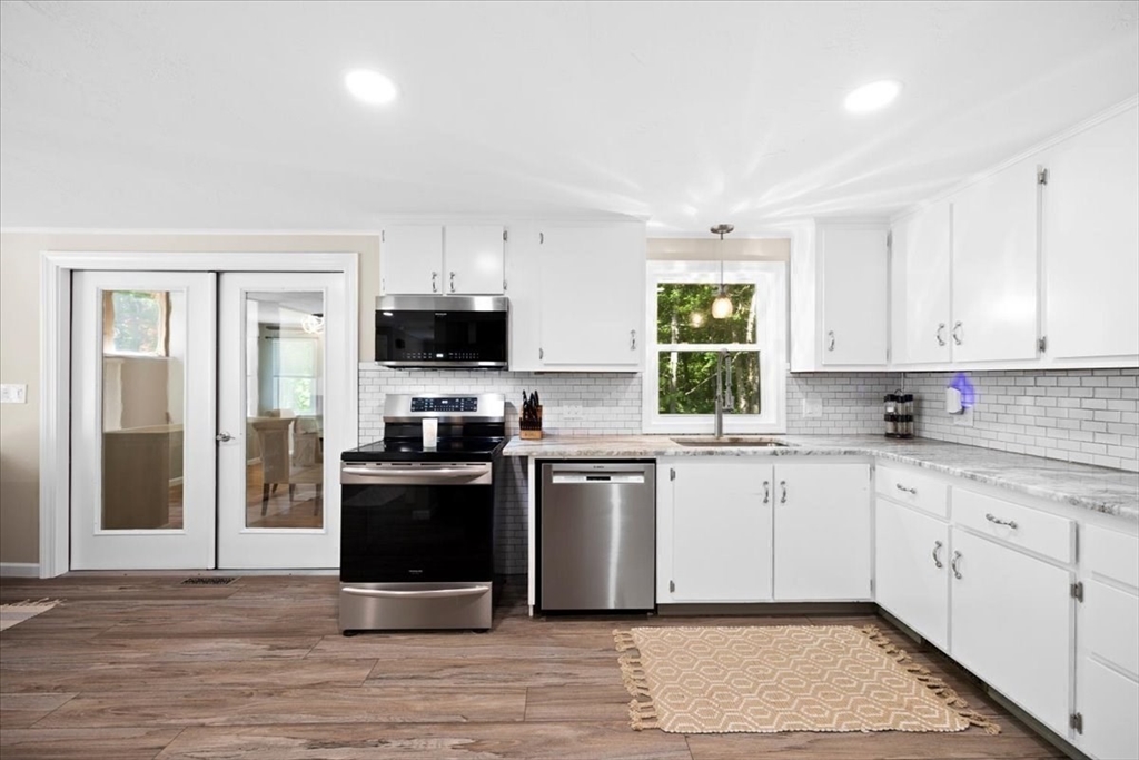 115 Douglas Road Webster, MA 01570 - Photo 12 of 42 a kitchen with a stove a sink and a window
