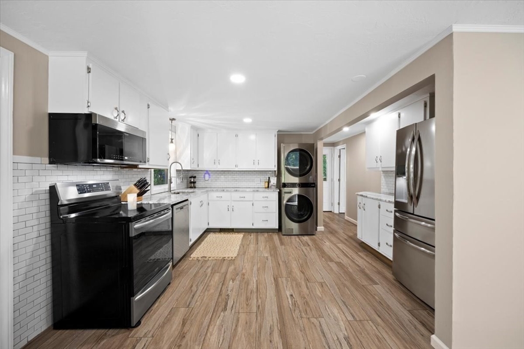 115 Douglas Road Webster, MA 01570 - Photo 13 of 42 a kitchen with a refrigerator stove top oven and sink