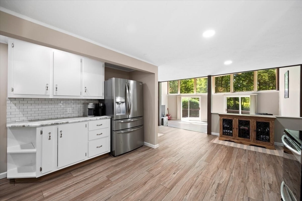 115 Douglas Road Webster, MA 01570 - Photo 14 of 42 a kitchen with stainless steel appliances a stove top oven and wooden floors