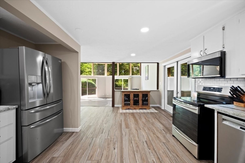 115 Douglas Road Webster, MA 01570 - Photo 15 of 42 a kitchen with stainless steel appliances a refrigerator microwave and stove