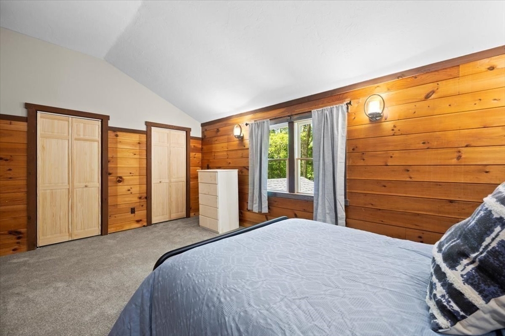 115 Douglas Road Webster, MA 01570 - Photo 32 of 42 a bedroom with a large bed and a large window